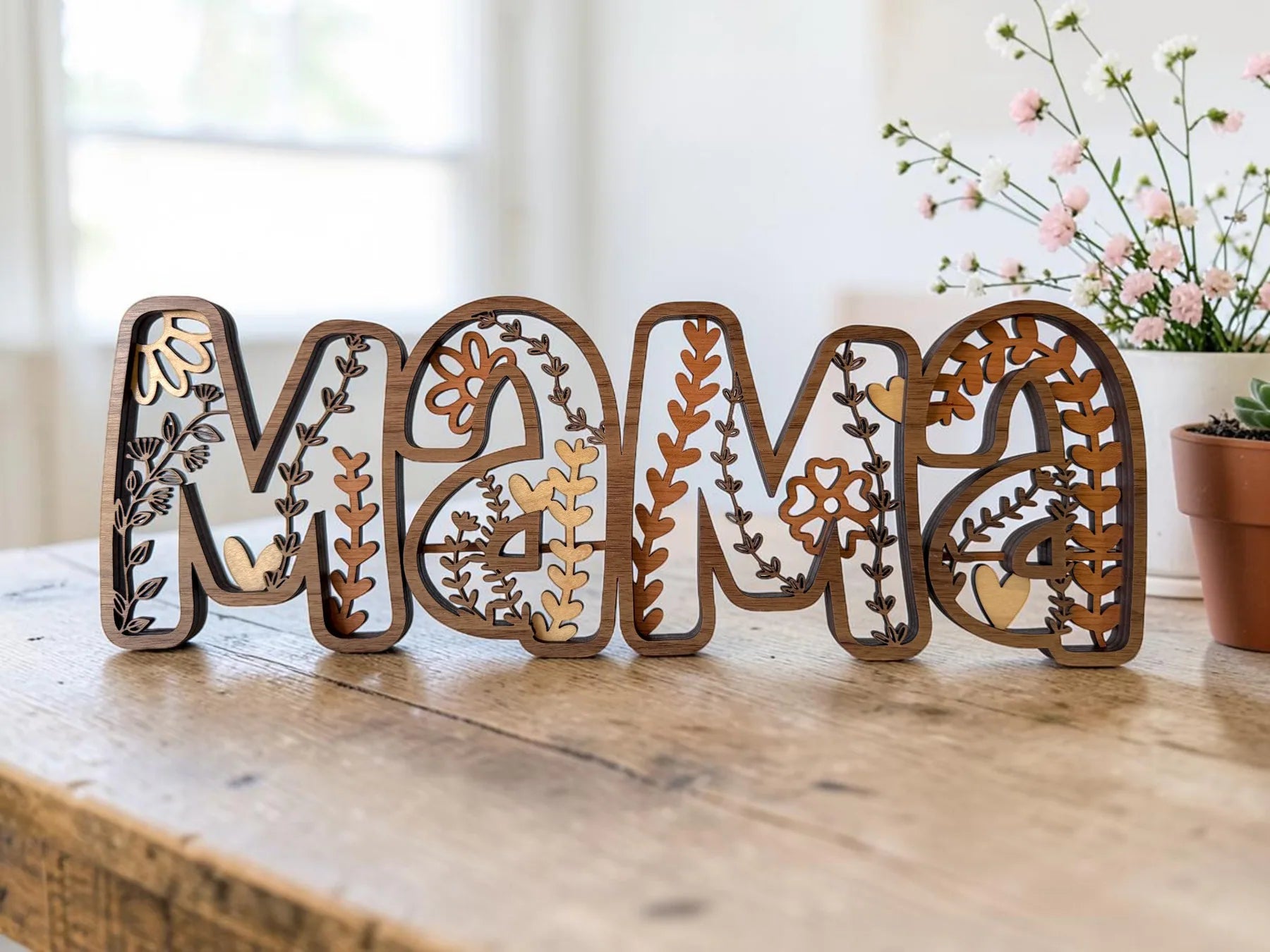Layered wooden MAMA sign standing on a table